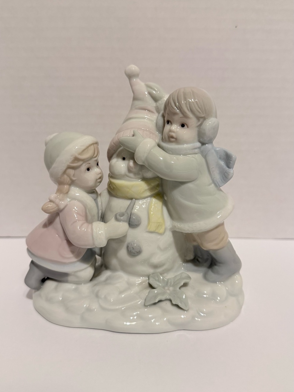 Porcelain Children Building Snowman Figurine in Pastel Colors